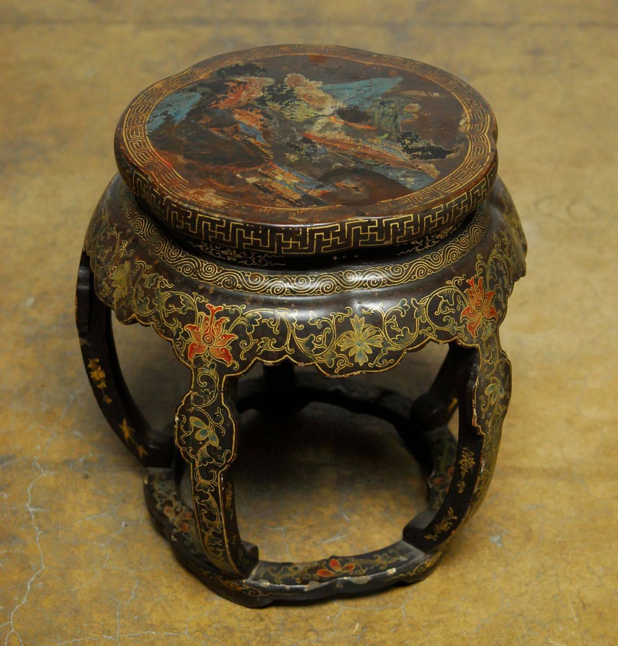 Chinese carved garden seat featuring a black lacquer finish with gilt decoration of flowers, Greek keys, and mountain scene on the top. Five leg design with a pedestal form and a lovely vintage patina. Would make a great cocktail or side table.