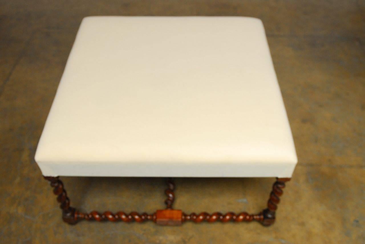 Generous Louis XIII style ottoman or bench in a square form featuring hand-carved barley twist legs and stretchers ending with toupie feet. Upholstered with a padded cushion and finished in muslin, ready for custom fabric. Shape and sized for use as