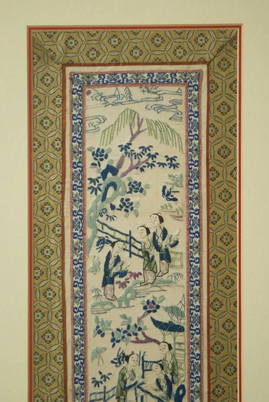 Antique Chinese silk embroidery panel from the 19th century depicting various scenes of the wealthy and elite in ancient times. Mounted in a plexiglass frame with wood trim and brass hardware. The tapestry measures 8