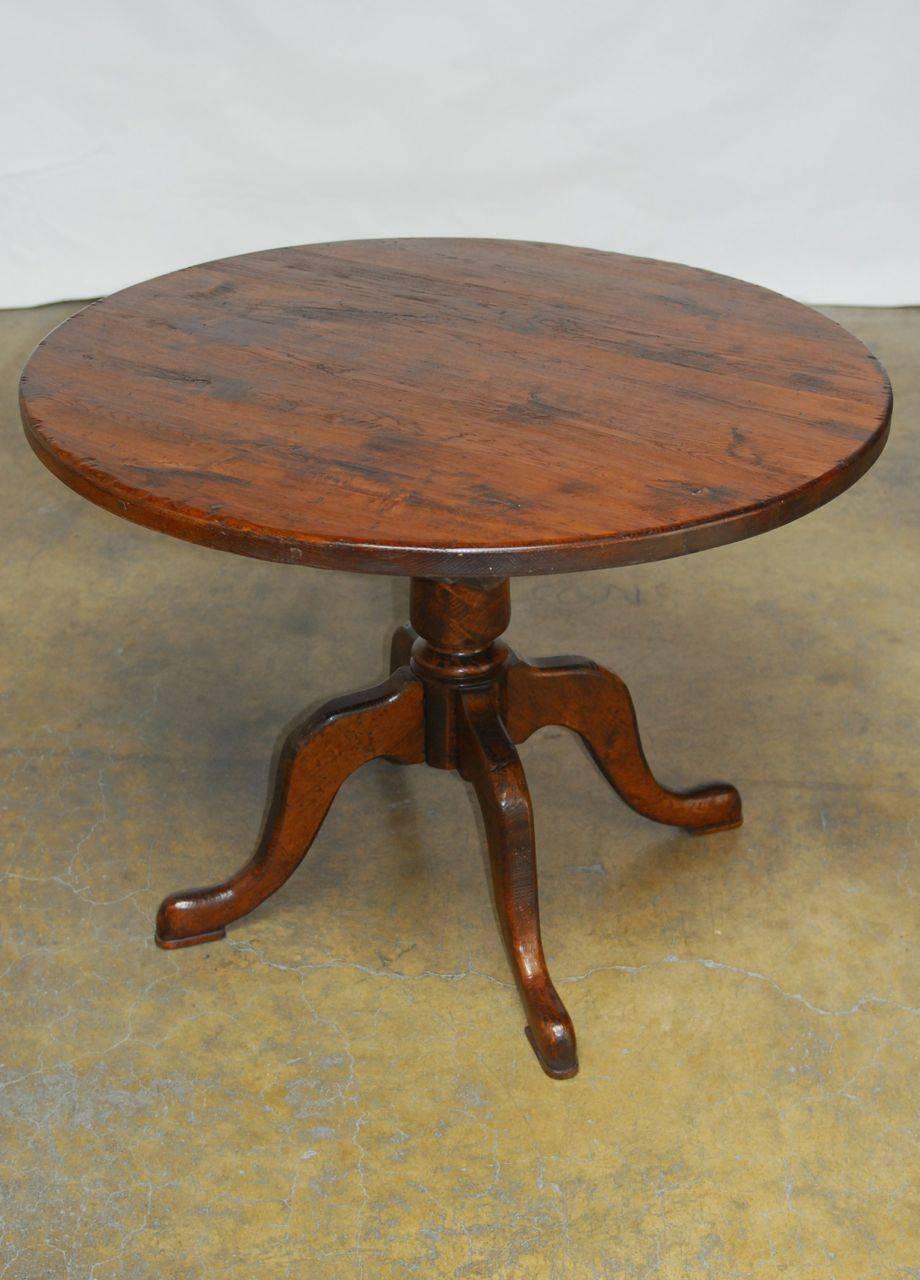 Remarkable solid oak round dining table that weighs over 100 lbs. Features a 1.5