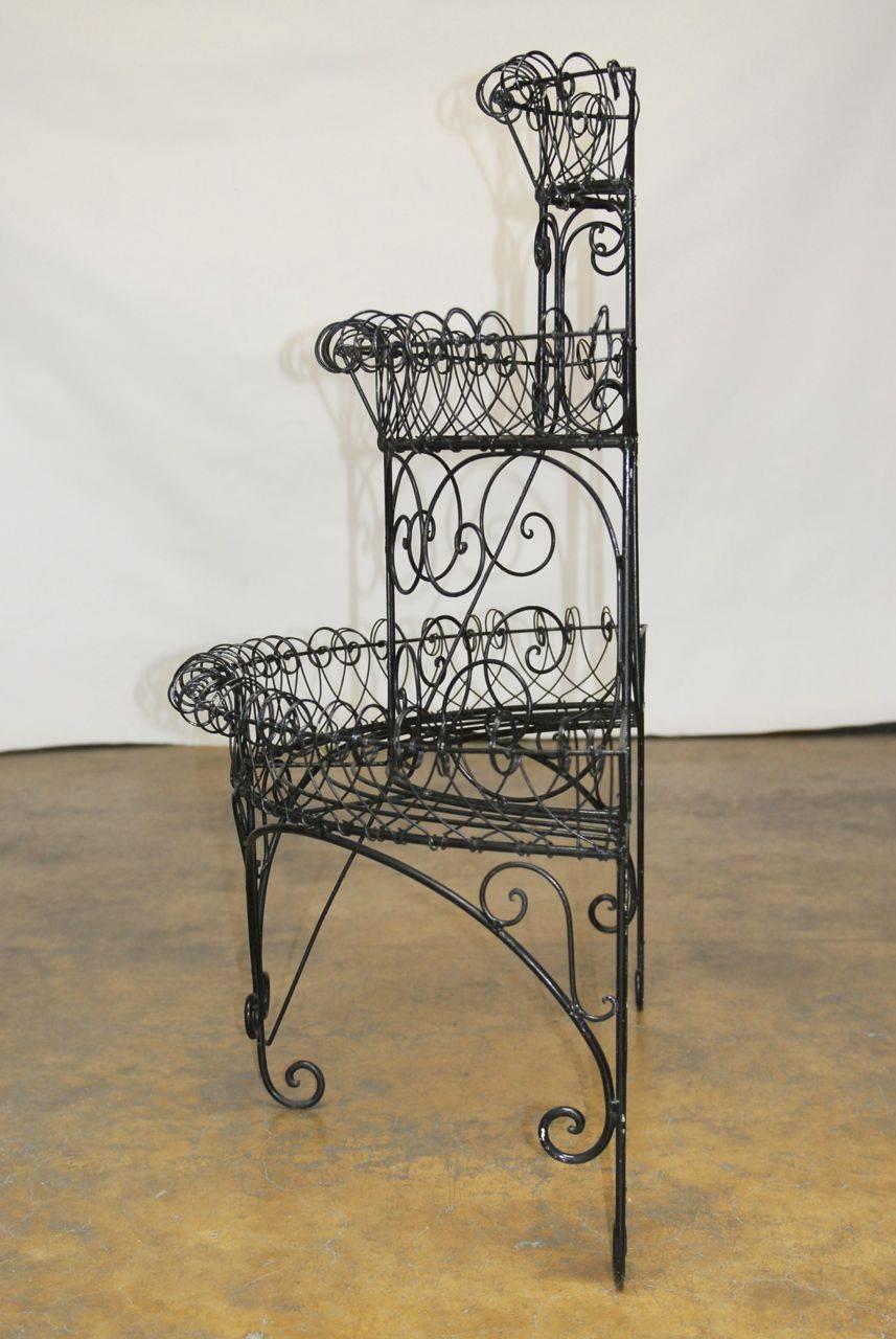 Fantastic three-tier French plant stand with a demilune shape. Features a fresh black finish with lots of hand formed wire scrolls.