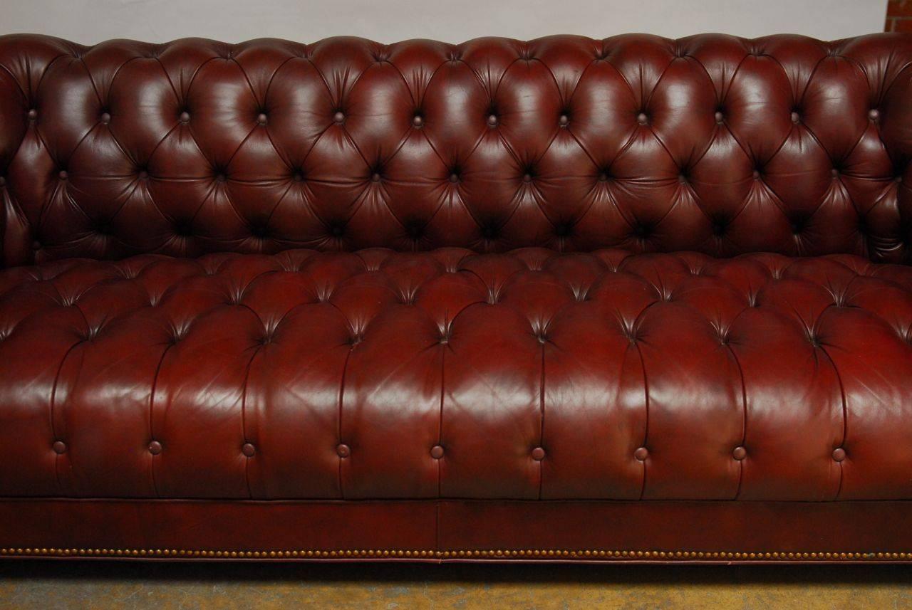 Opulent reinterpretation of the famous Chesterfield sofa by Emerson in Hickory, North Carolina. Features deep buttoned top-grain leather hide on a solid hardwood frame with rolled arms, and a low back. Finished in a soft cordovan leather with