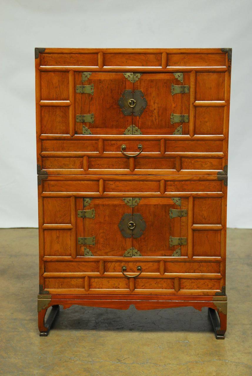 Elegant 19th century Japanese stacked clothing chests on stand featuring delicate brass hardware and trim. Richly grained wood panels make this a beautiful display piece. These chests were made in the tansu style in Japan and Korea and designed for