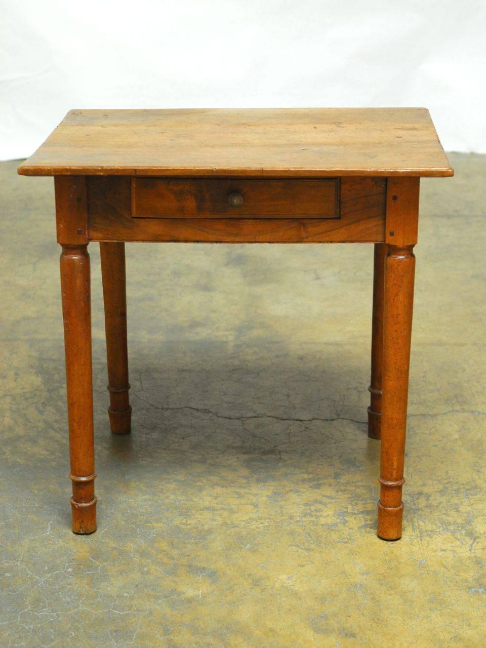 Beautiful 18th century French oak petite desk or work table featuring a single drawer and the original distressed patina that lends character to the piece. Supported by unique round legs and feet and constructed with wood peg joinery. Simple