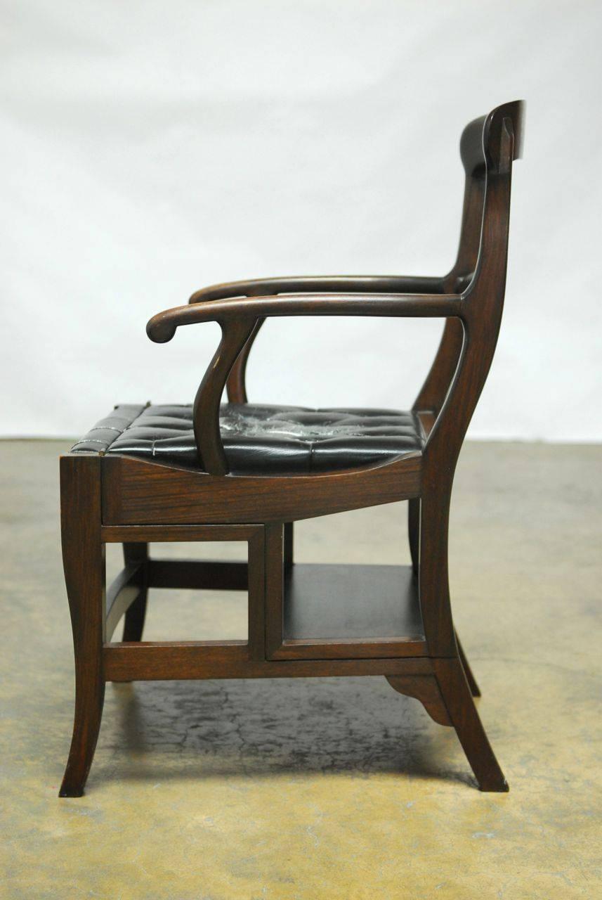 Gorgeous Hong Kong colonial rosewood library chair copied from a 19th century piece by noted custom antique dealer Charlotte Horstmann. Exceptional quality piece made for a discerning client. Features a carved rosewood four step frame with a tufted
