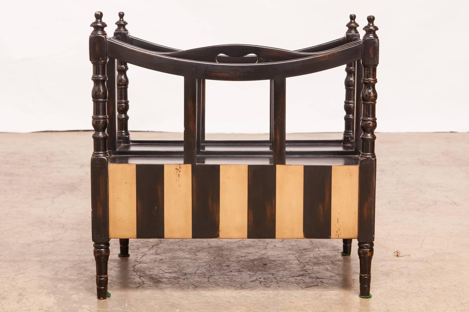 Gorgeous French style Canterbury featuring an ebonized lacquer finish with ivory accent stripes by Theodore Alexander's 