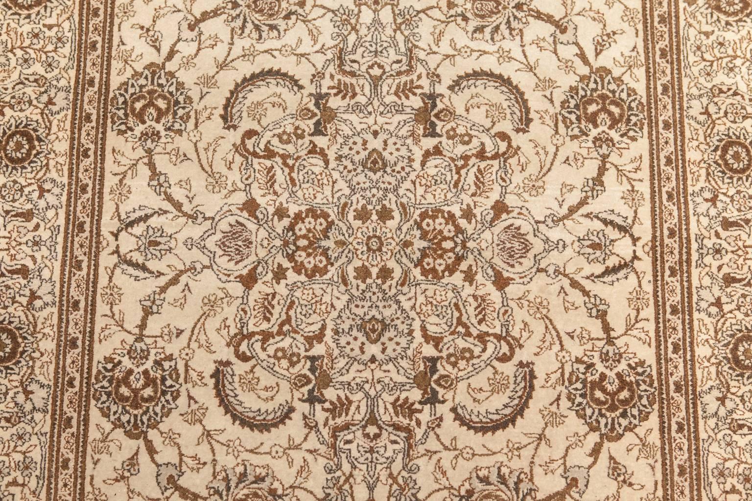 Elegant vintage Persian Qum rug made of hand-knotted wool featuring an amazing intricate scrolling vine pattern with a lovely faded patina. Very subtle grey shading can be seen in the delicate leaves and foliage patterns over a cream ground.