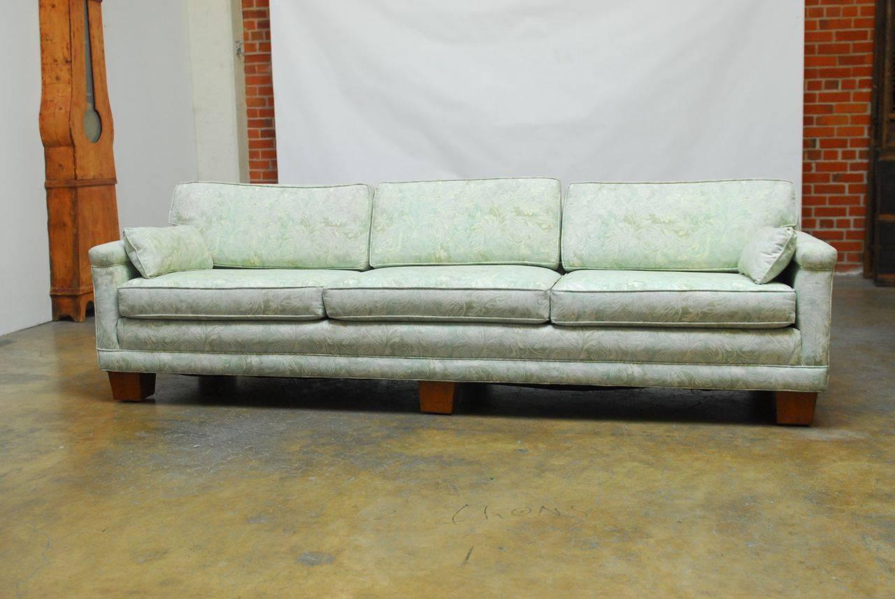 Spectacular Mid-Century sofa featuring a vintage Fortuny style upholstery in a cool mint green color. Long modern low-back style sofa supported by six square wooden feet. Excellent craftsmanship with generous seating for four. The fabric features a