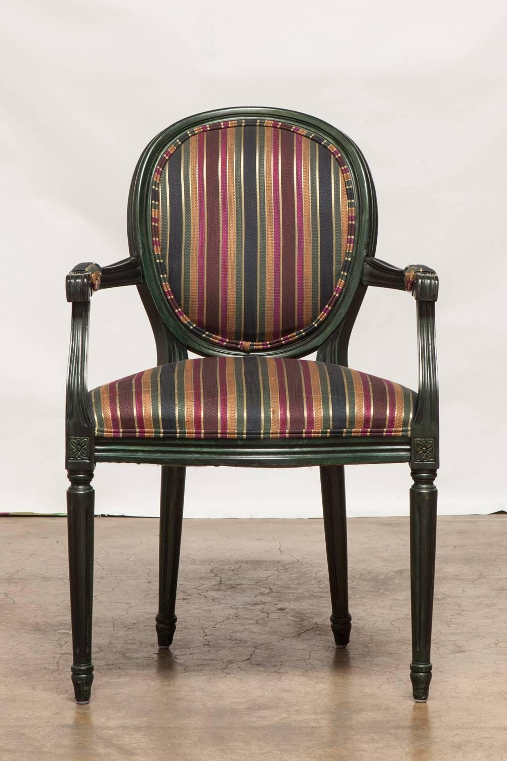 Chic set of French Louis XVI style armchairs featuring a dark malachite green lacquer finish. Upholstered in a striped pattern brocade fabric. Made in Italy for 