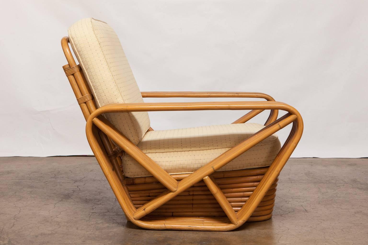Fabulous pair of pretzel lounge chairs by Kosuga for Paul Frankl made in Tokyo, Japan. Featuring authentic steam bent rattan frames. Custom ordered with six strand arms from the original manufacturer. Purchased from the original owner and includes a