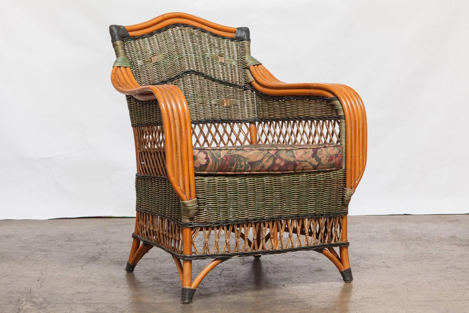 Artistic pair of French rattan armchairs made by famous maker Grange in the Art Deco style. Featuring wide five strand rattan arms accented by green wicker covered frames. The backs have a camel back hump and the seats have a removable upholstered