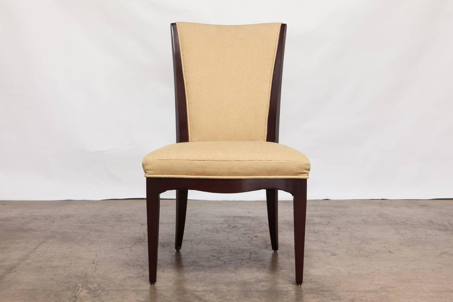 Modern set of mahogany dining chairs by Baker Furniture Co. designed by Barbara Barry. Featuring sleek mahogany frames with a serpentine seat and supported by tapered legs. Set consists of two armchairs and four side chairs. Upholstered in the