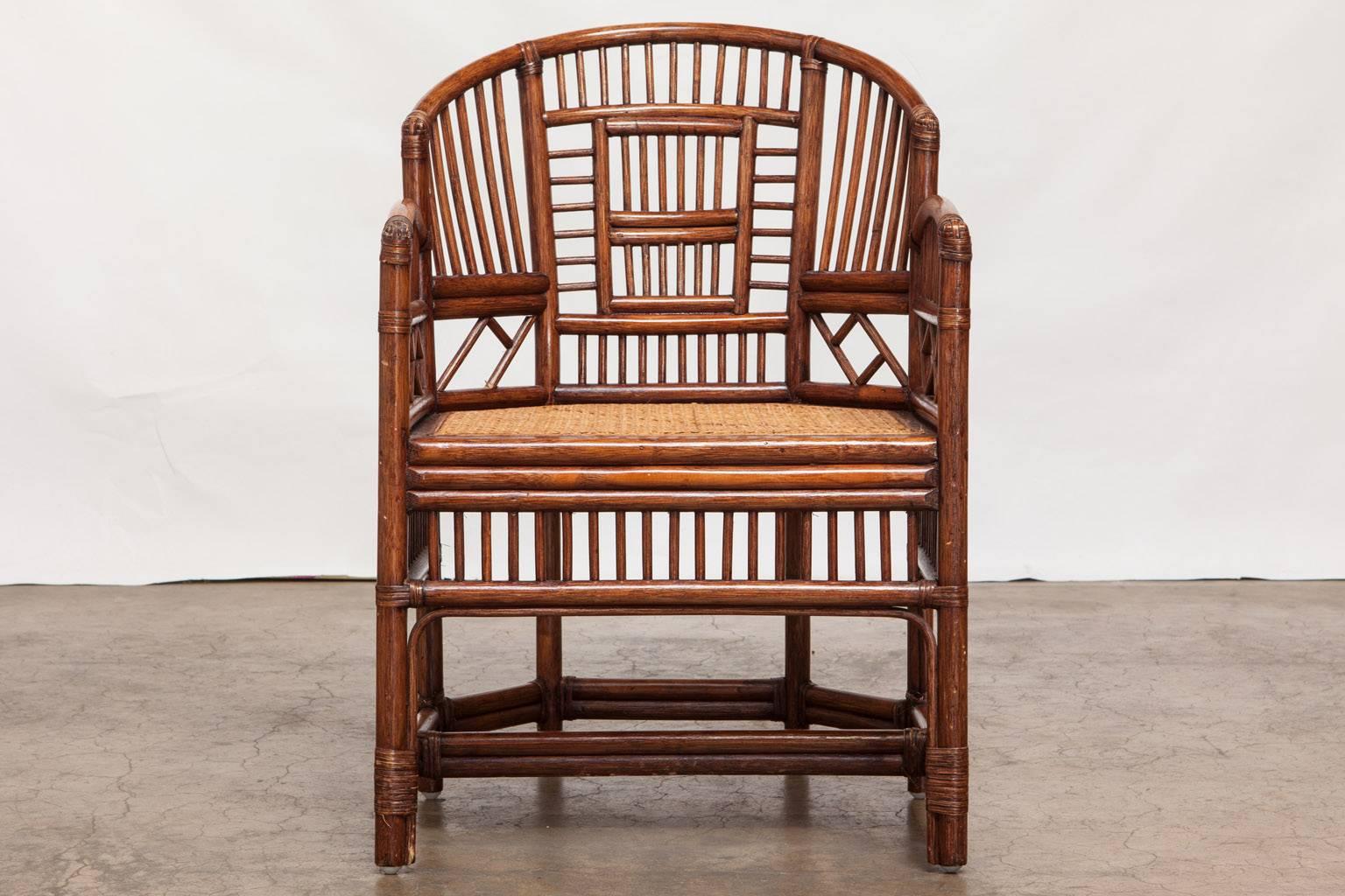Handsome pair of bamboo rattan armchairs made in the Brighton Pavilion style. Featuring an open fretwork lattice design and a cane seat. Finished in a dark shade.