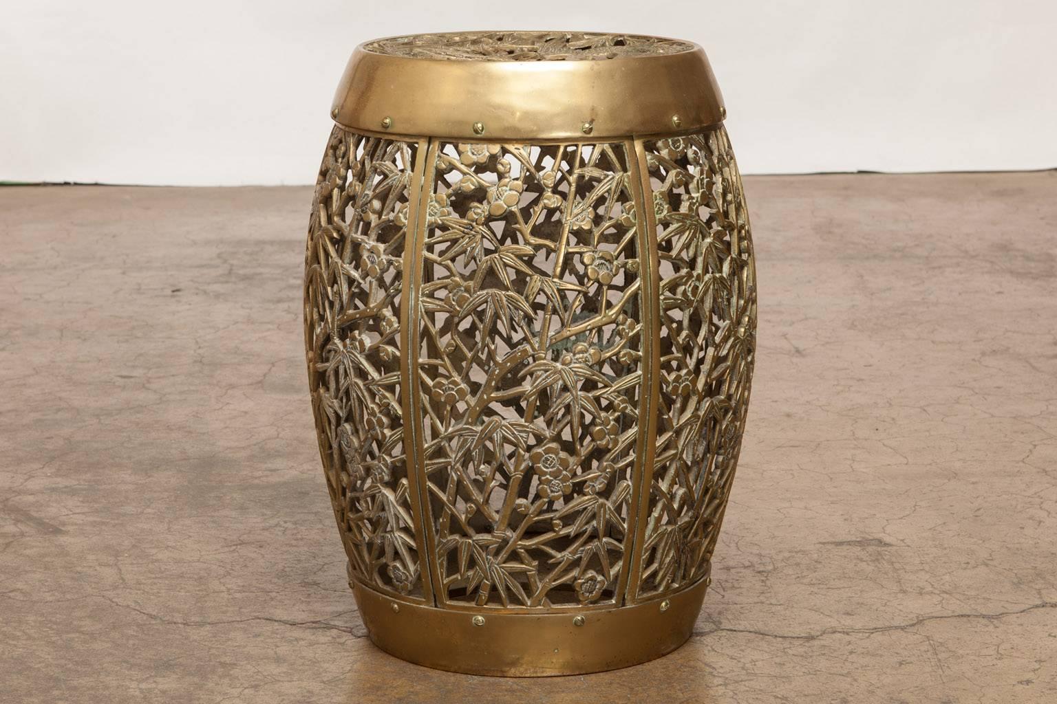 Fantastic Chinese pierced brass drum drink table or garden stool. Made in the tabouret style featuring an elaborate open fretwork cage design of bamboo and foliage on the sides and birds decorate the seat. Deceptively heavy solid piece of furniture
