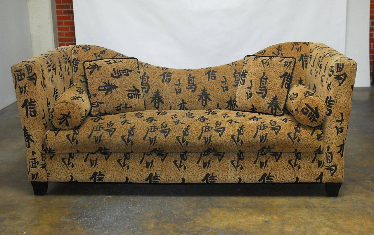 Chic, modern sofa featuring an Asian Chinese script upholstery over a curvaceous frame. Deep, comfortable seating area with a wide cushion and nearly flat sides. This unique sofa draws your attention and includes two bolsters and two throw pillows.