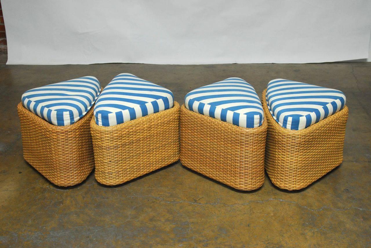 Stylish wicker sushi low-table with ottomans by Gloster. Features a clever design made of man-made, weather resistant wicker. Each stool seat has an aluminium frame covered in wicker with a padded cushion. The table base is made to support a 48