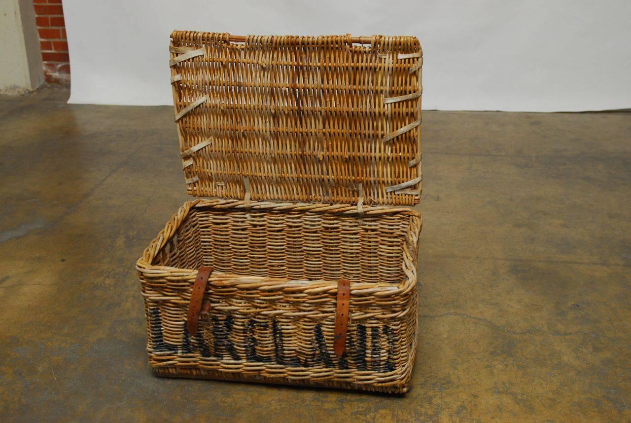 Rare WWII English military basket, circa 1930. Made of rattan and wicker with a wooden frame. Features rawhide strapping and reinforcement with leather strap closures. Painted on the front Lakeland and on the back Lancaster.