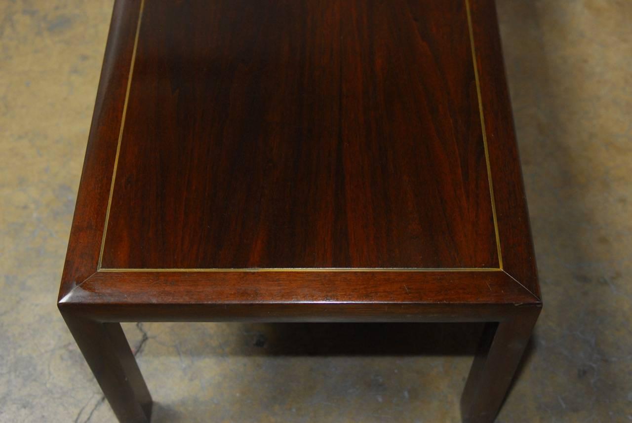 Handsome mahogany bench or long coffee table made from a beautifully grained top plank of mahogany. Featuring a brass trim inlay around the border. Minimalist style supported by six square legs with makes it strong and stable. Could be used as a low