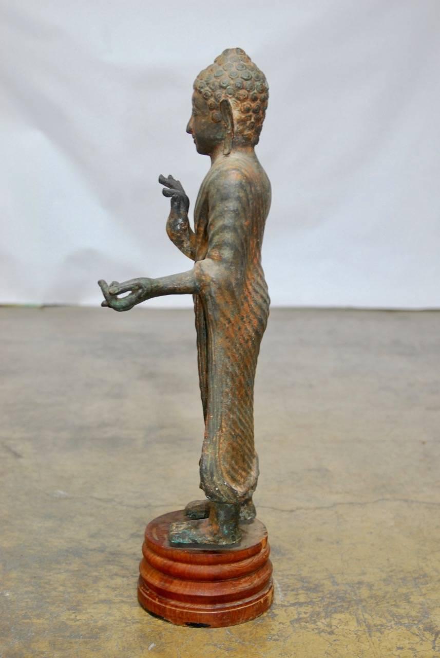 Wood Cast Iron Standing Buddha on Stand For Sale