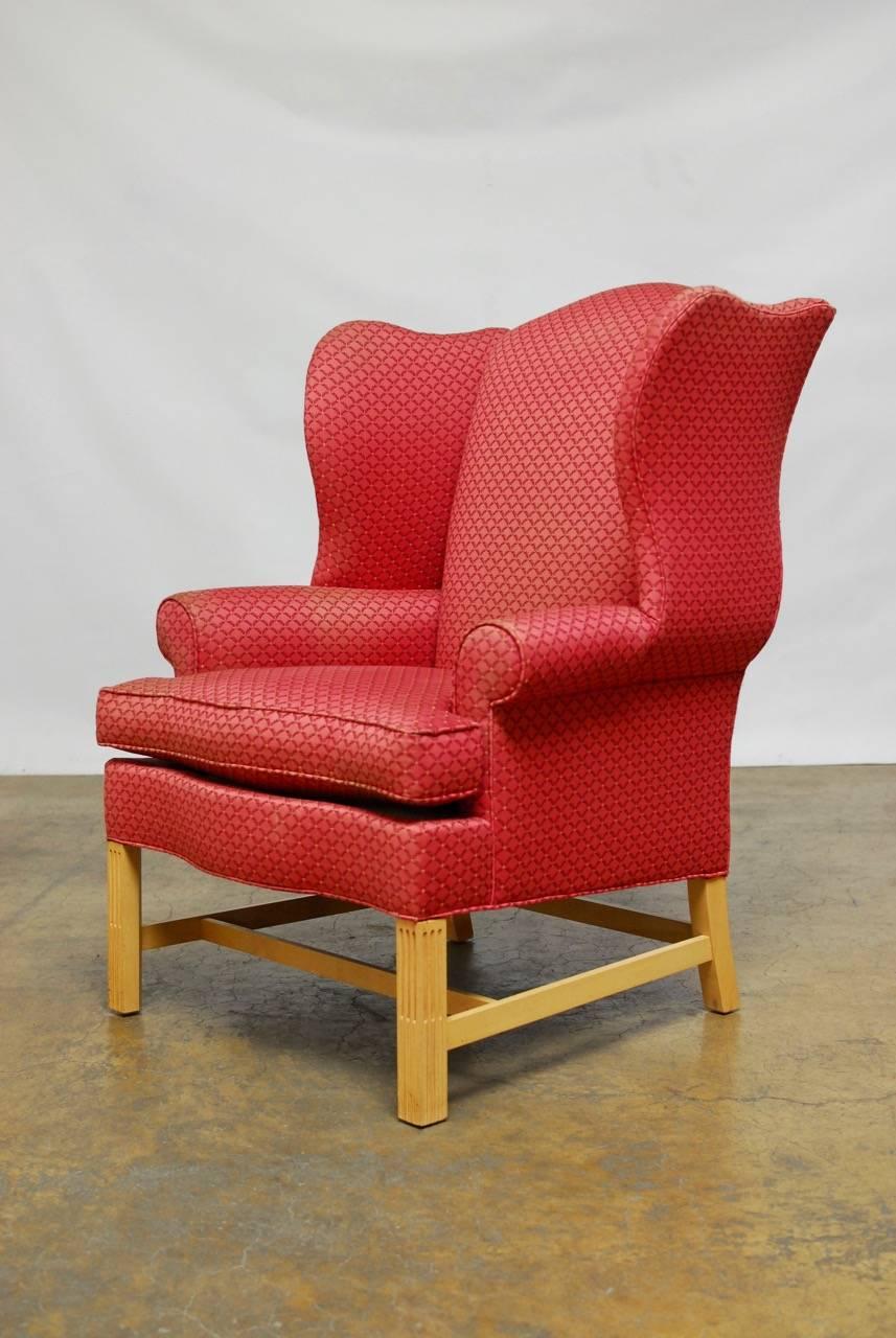 Generous pair of wingback chairs made in the Chippendale style by Drexel Heritage. Featuring large proportions upholstered in original fabric that needs updating. Fully developed wings with a serpentine seat supported by square reeded legs in a