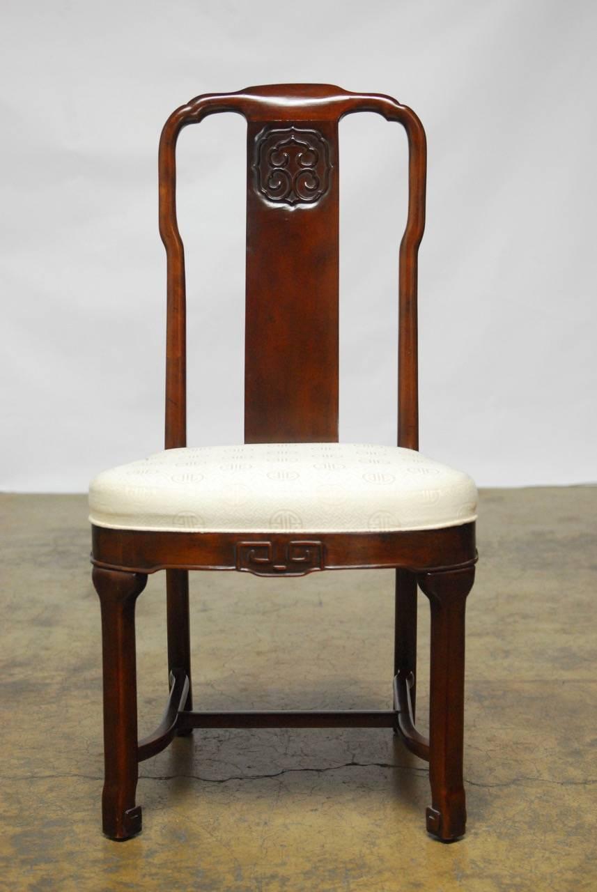 Rare set of seven Chinese Ming style mahogany dining chairs by Drexel Heritage. Featuring a carved mahogany frame decorated with a Ruyi cloud design backs plat and Greek key motif design apron and feet. Set is comprised of two armchairs and five