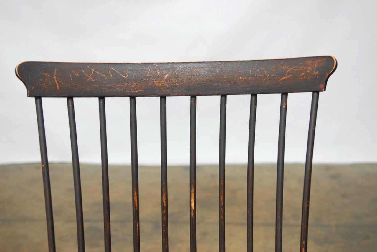 Rare and unusual American high back or comb back windsor chair with a ten spindle back support. Featuring graduated orb arm supports and matching legs with intricate round turnings. The chair has a unique profile with splayed legs in the rear and