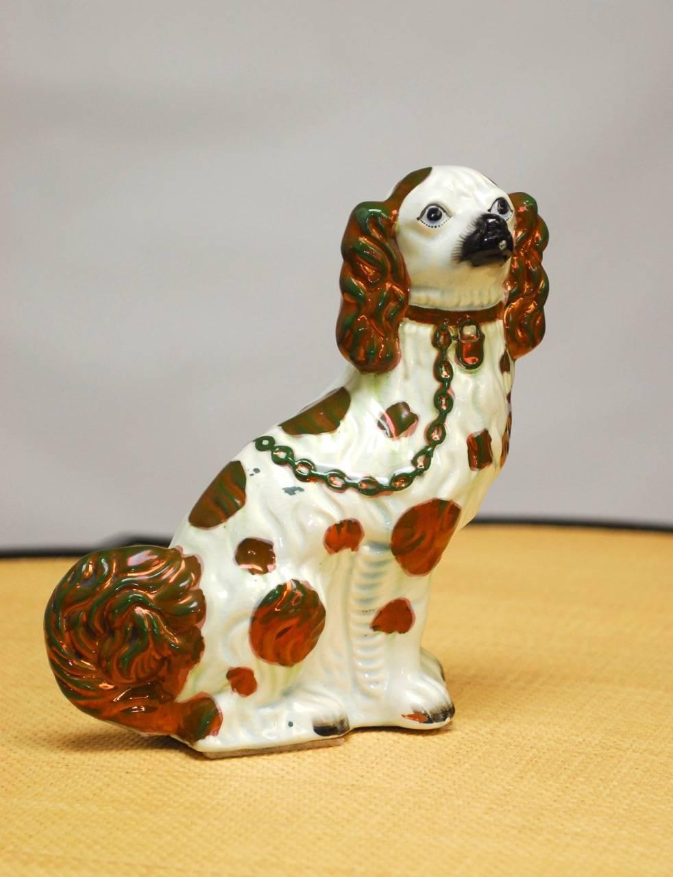 Fine pair of English Staffordshire porcelain Spaniels featuring white glazed bodies with metallic accents. Extraordinary craquelure finish and facial expressions.