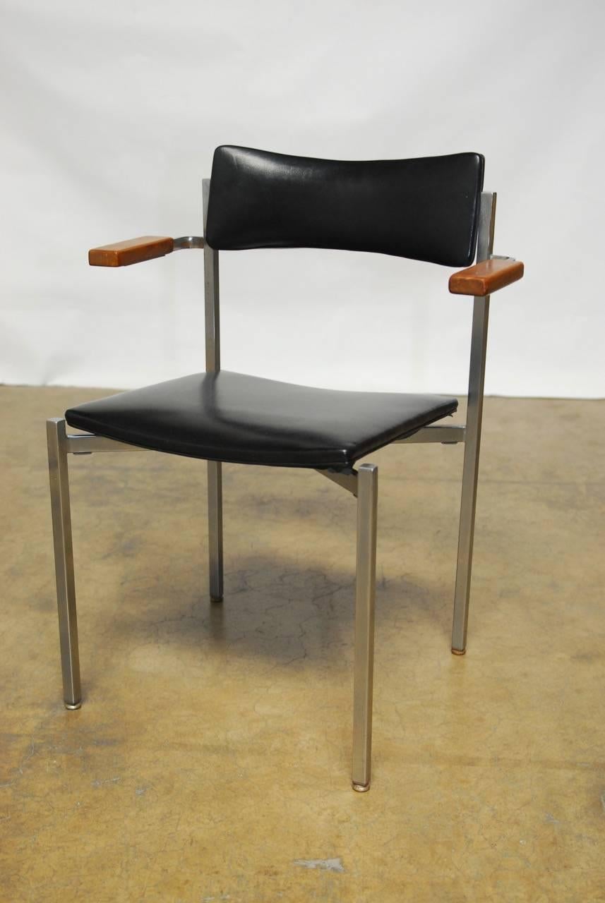 Rare pair of Mid-Century office chairs by prolific artist and designer Frederic Weinberg who became famous for his sculptures. Constructed from flat bar steel frames that are polished and feature wood armrests with black vinyl seats and backs.