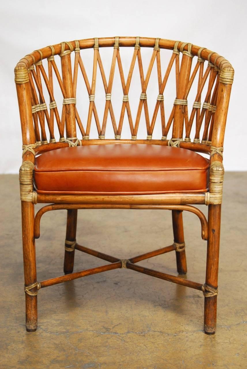 Fabulous set of 50 bamboo barrel chairs by McGuire featuring extensive fretwork backs and rawhide strapping with cognac leather seats. Provenance: From the iconic Lion's Pub in Pacific Heights, San Francisco, CA. Makers label affixed to bottoms.