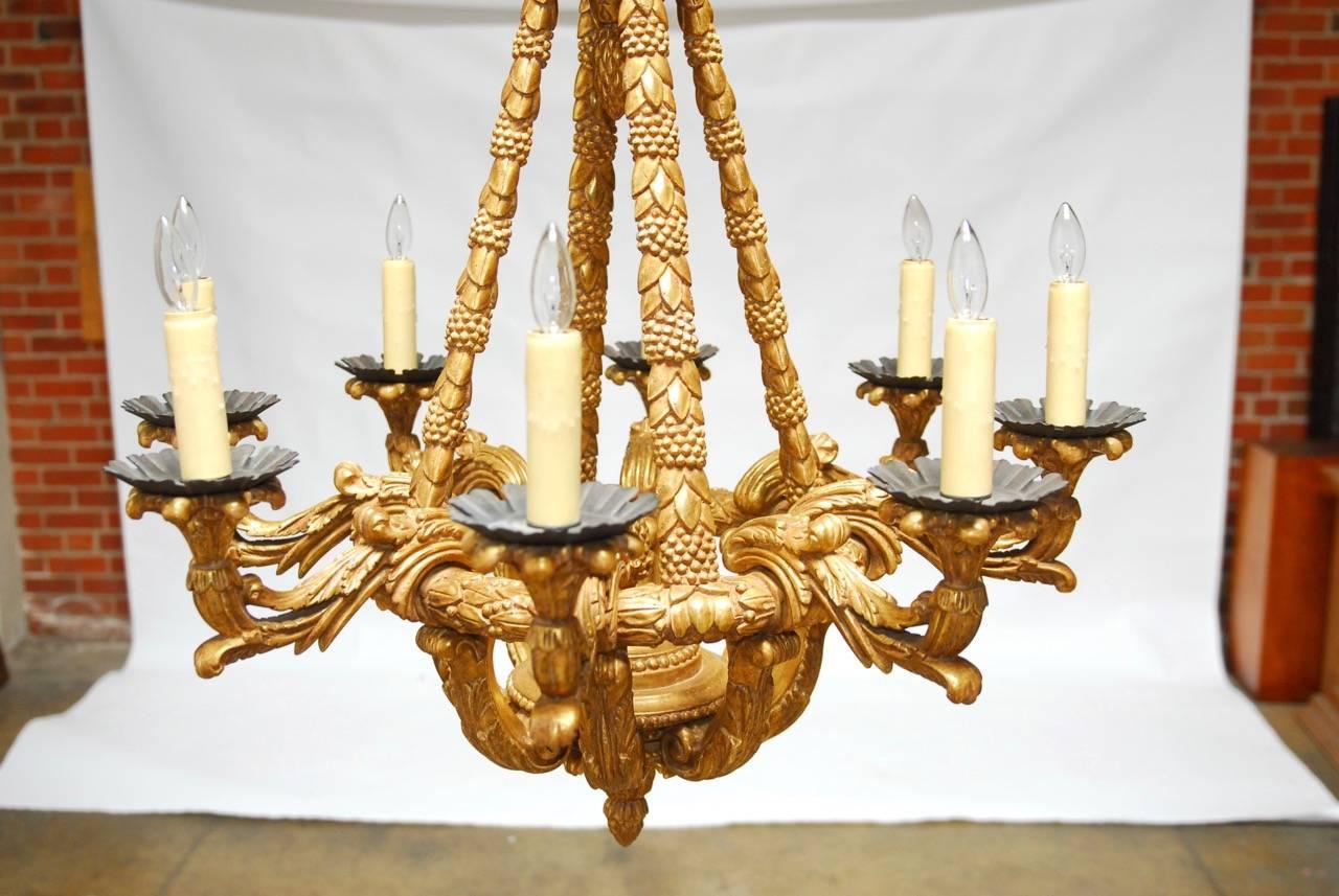 2006 Paul Ferrante Medici model eight-light giltwood chandelier made in the Rococo taste. Featuring a hand applied 22 karat gold leaf finish. Provenance: Historic St. Helena winery estate. This exquisite chandelier can be seen in 