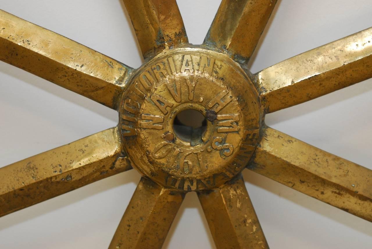 Historical British Navy Victorian solid brass ships wheel stamped and dated (circa 1910) featuring an eight spoke wheel with eight brass handles. Very heavy and substantial weighing nearly 100 lbs. Stamped on hub 