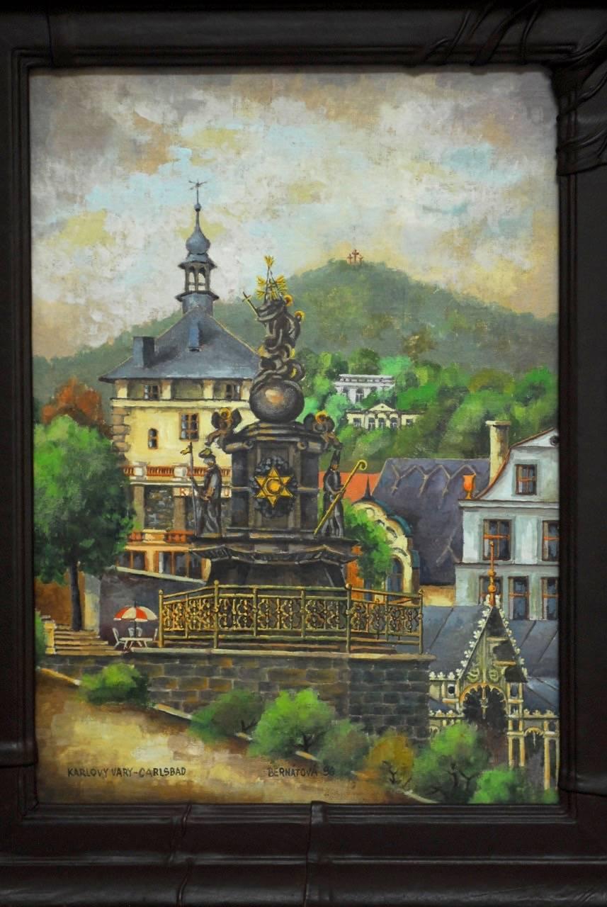 Beautiful oil on board painting of Carlsbad or Karlovy vary in western Bohemia. Depicts a Baroque statue from 1716 and a Gothic castle in the background founded in 1358. Artist signed Bernatova lower center and dated '96. Framed in a rich leather