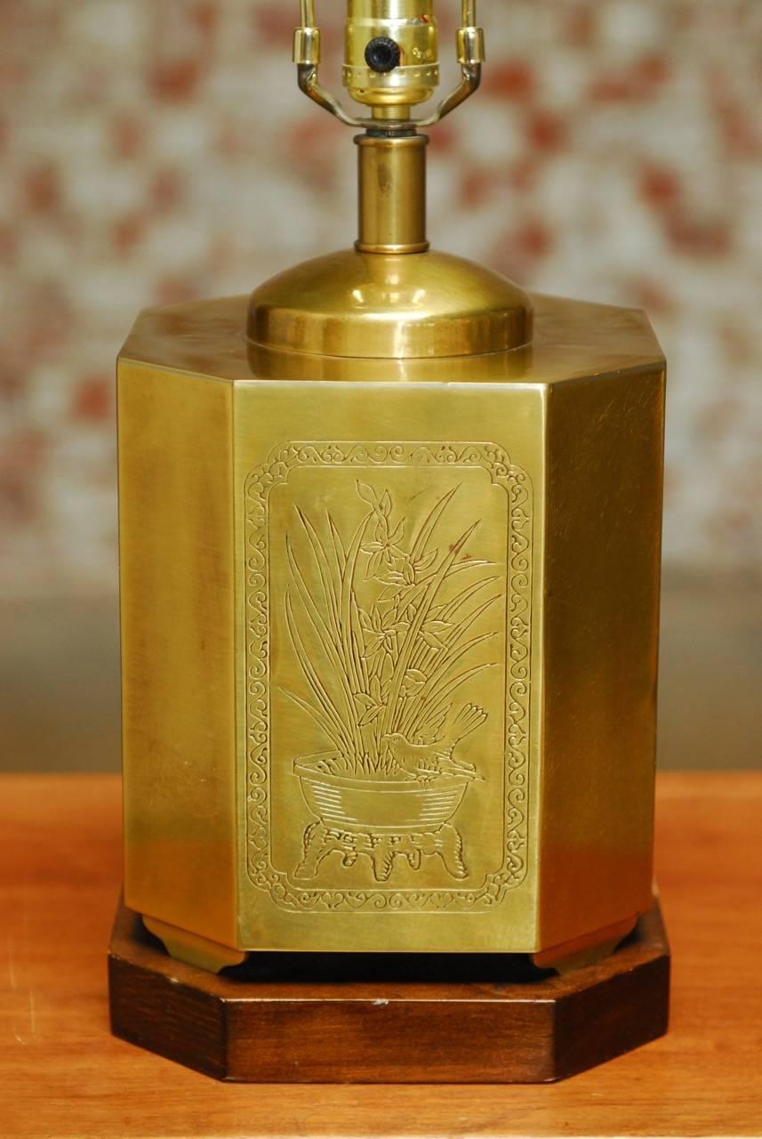 Distinctive Chinese incised brass tea canister or tea caddy table lamp. Features an octagonal shaped body decorated on four sides with scenes of bamboo, foliate, and birds. Supported by shaped feet and mounted to a wooden conforming base. The