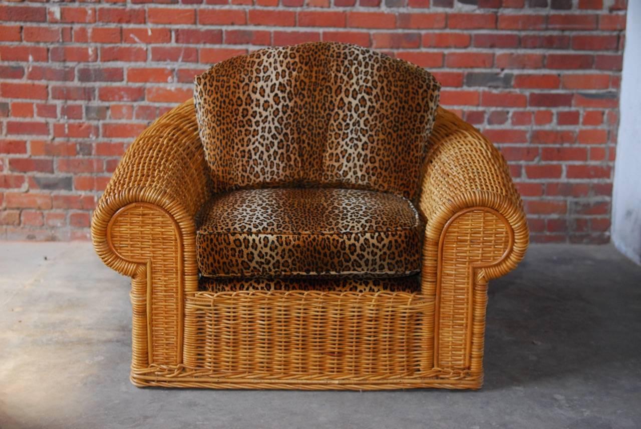 Handsome Michael Taylor inspired wicker lounge chair and ottoman custom-made by "The Wicker Works" in San Francisco, CA. Features a Scalamandre style leopard upholstery over a natural finish woven wicker frame. Large sculptural design