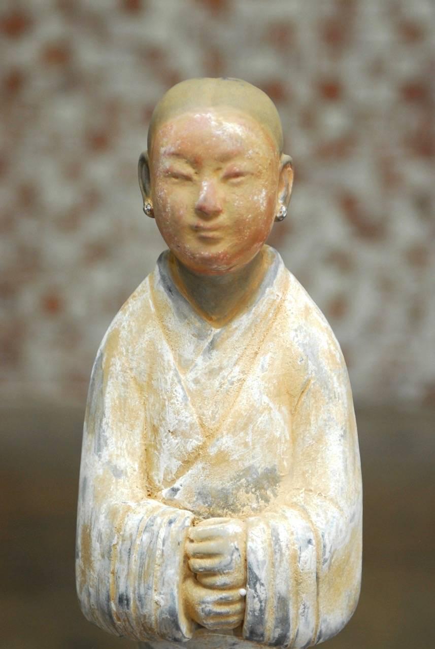 Traditional Chinese Han Dynasty style ceramic pottery figure or attendant dressed in a robe. Features a beautiful antique pottery patina with lovely detail. Chinese export piece with artist stamp on the bottom. 