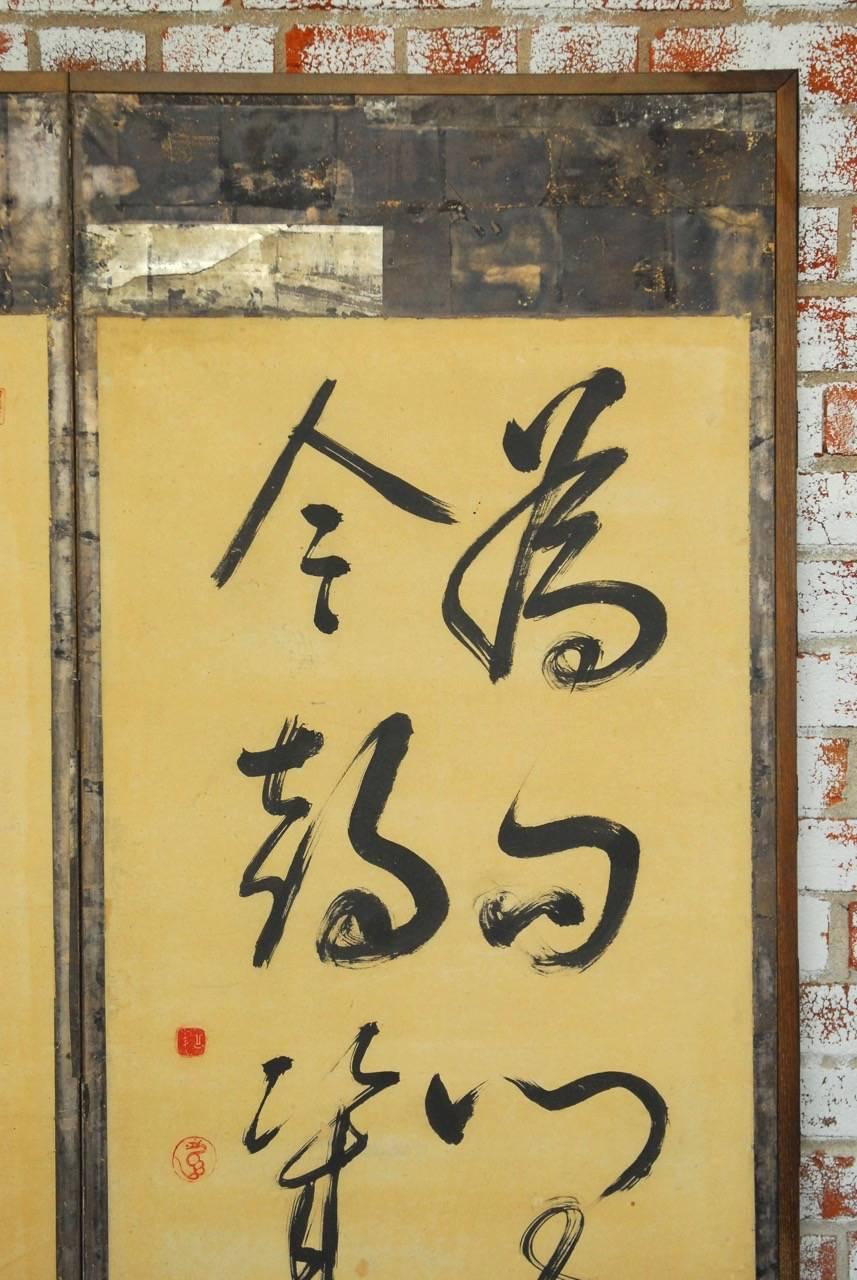 Large Japanese Edo period six-panel folding silver leaf screen featuring Chinese style brush calligraphy of a poem. Squares of silver leaf with a vintage patina and calligraphy script on verso as seen in losses. The front of the screen decorated