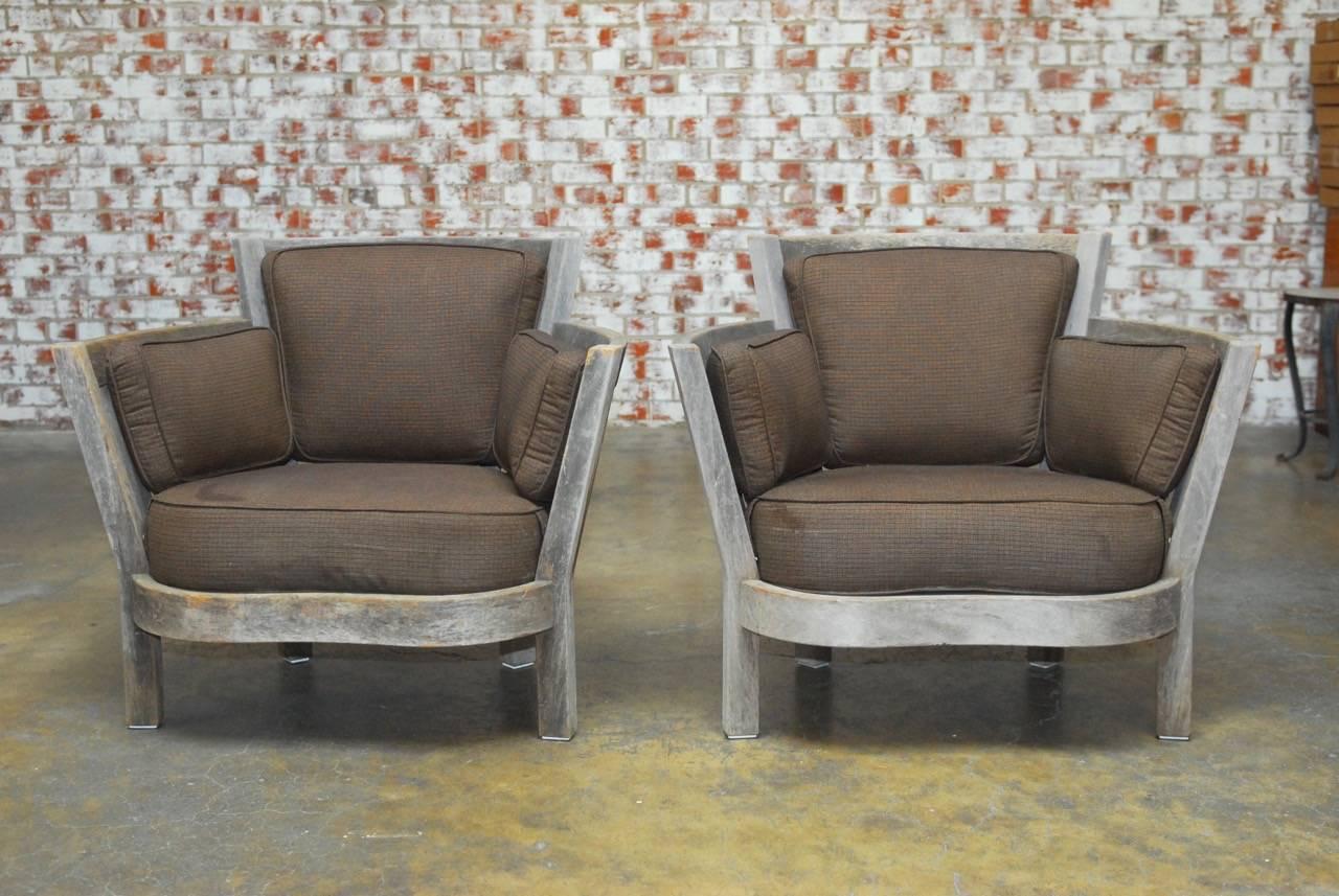 Grand pair of teak Westport armchairs made by Weathered Estate Furniture. Specializing in yacht style construction for the highest quality furniture in the world. These generous proportion lounge chairs have a barrel back form with a serpentine