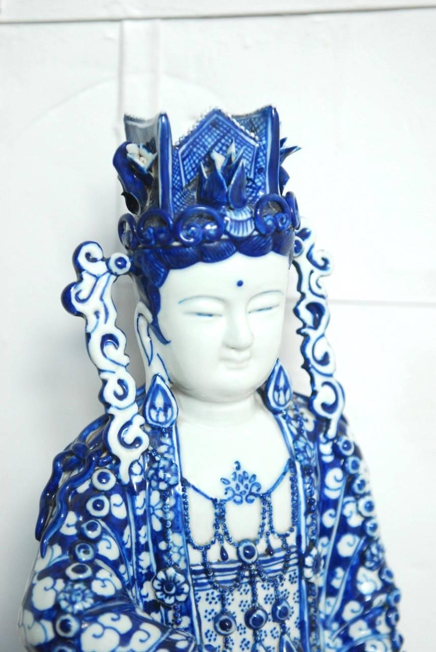 Stunning Chinese blue and white porcelain Guanyin statue from Fujian Guild in Fujian Provence, China. Depicted sitting with one leg up, this beautiful piece showcases the fine and intricate workmanship of the craftsmen. From the delicate fingers to