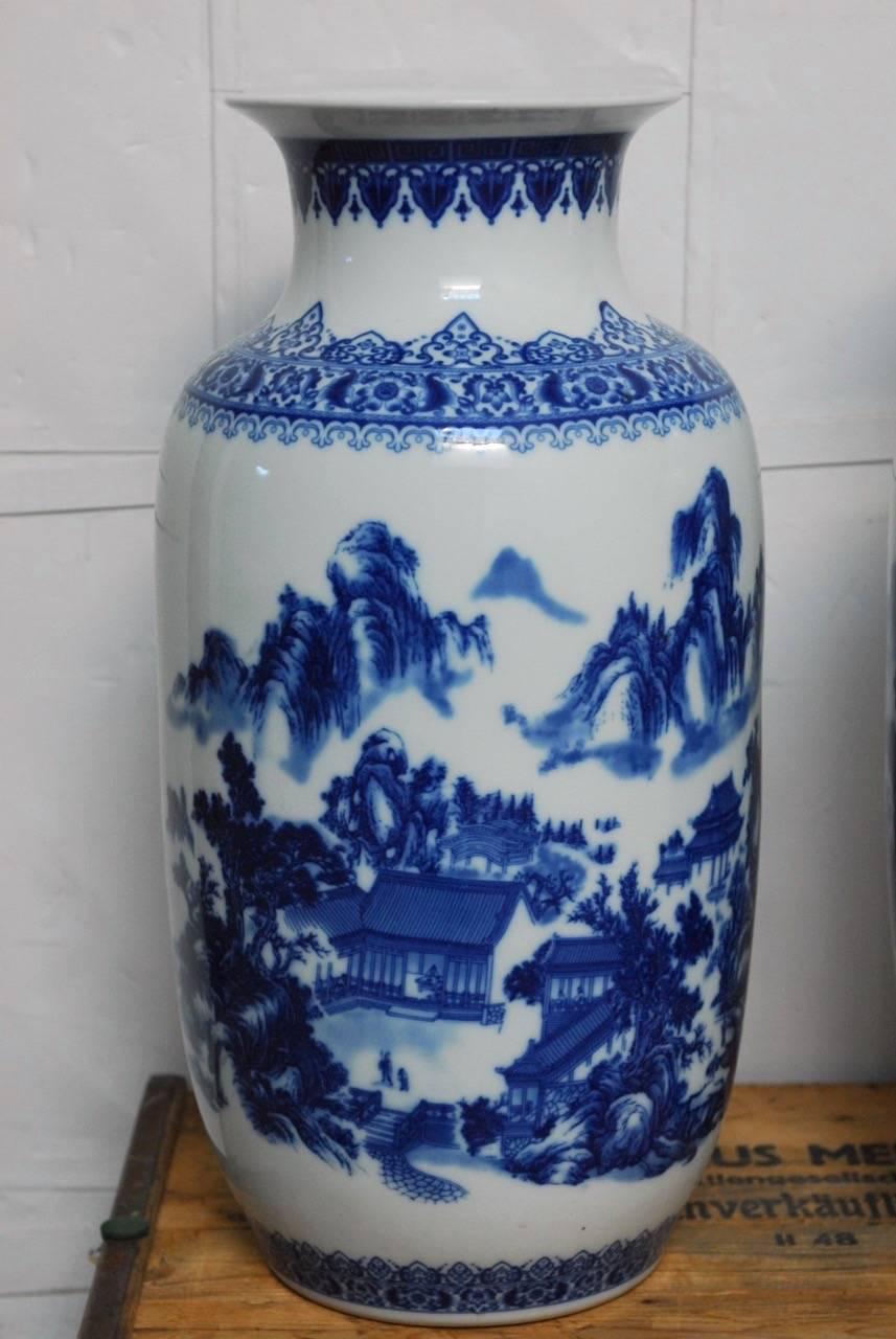Exceptional pair of Chinese Export blue and white porcelain vases. Featuring a large baluster form body with a high trumpet neck. Beautifully decorated with mountain landscapes and pagodas. Each having Chinese script on the back and stamped on