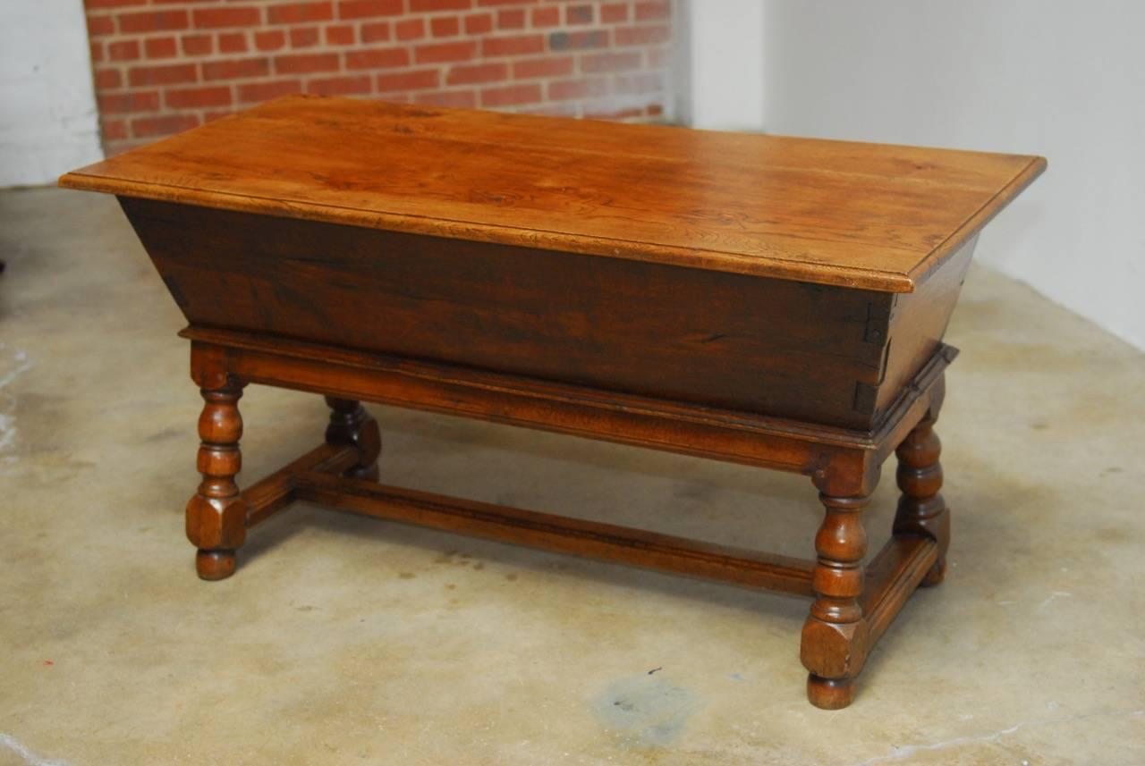 Rustic 18th century George III period Oak dough bin or baker's table with a removable plank top. Features exposed dovetail joinery on the case corners. Supported by a stand with baluster turned legs with peg joinery conjoined by large molded