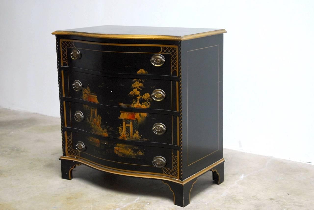 Mid-Century Modern chinoiserie decorated chest of drawers or dresser. Featuring a Jappaned black lacquer case with Asian scenes and gilt trim. Made in the manner and style of Drexel with a four drawer serpentine front. Supported by shaped feet.