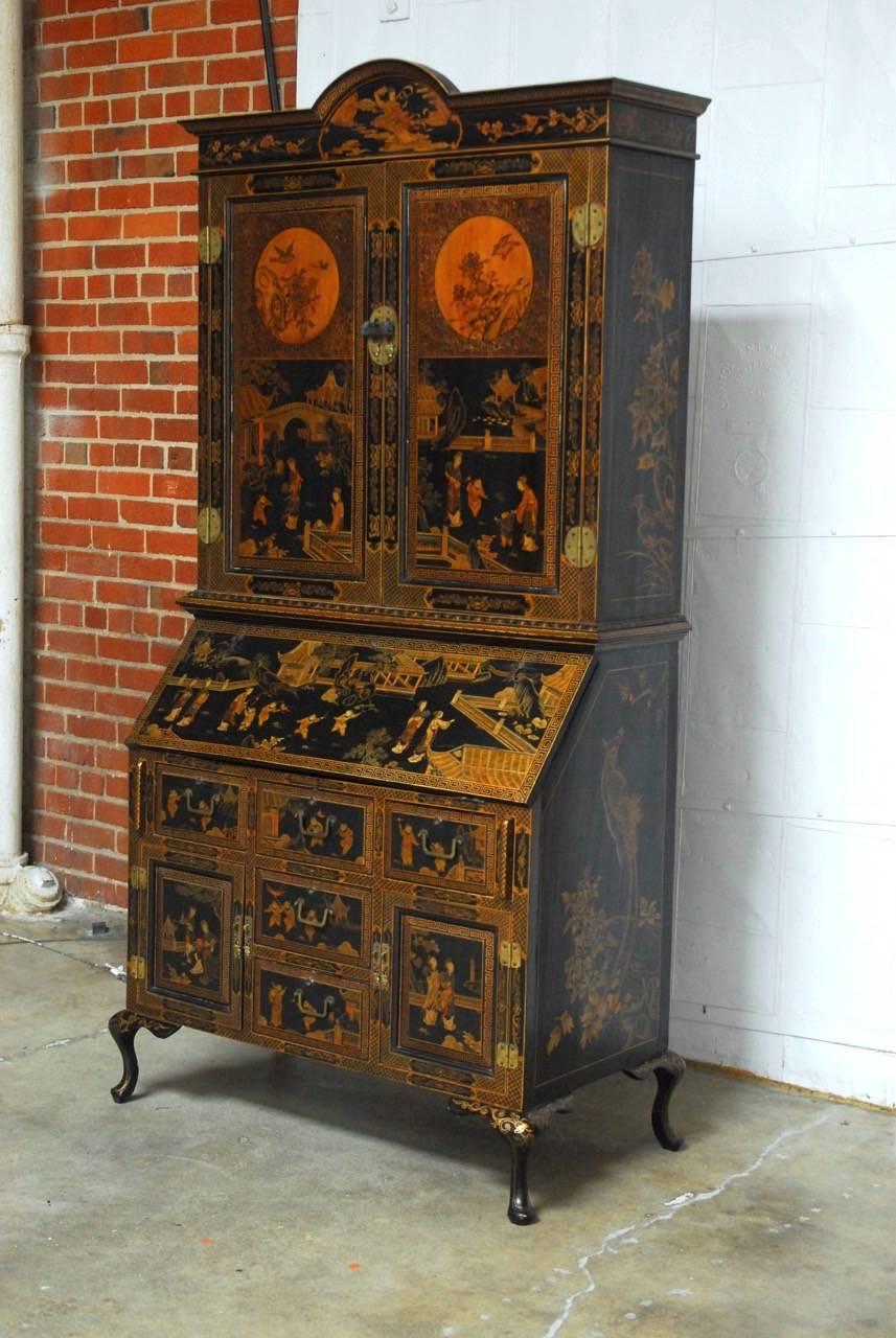 Grand 18th century English lacquered secretary cabinet made in the George III style and decorated in the chinoiserie taste. Features a Japanned case embellished with hand-painted intricate scenes of royal courtyards with pagodas and nobles in gilt.
