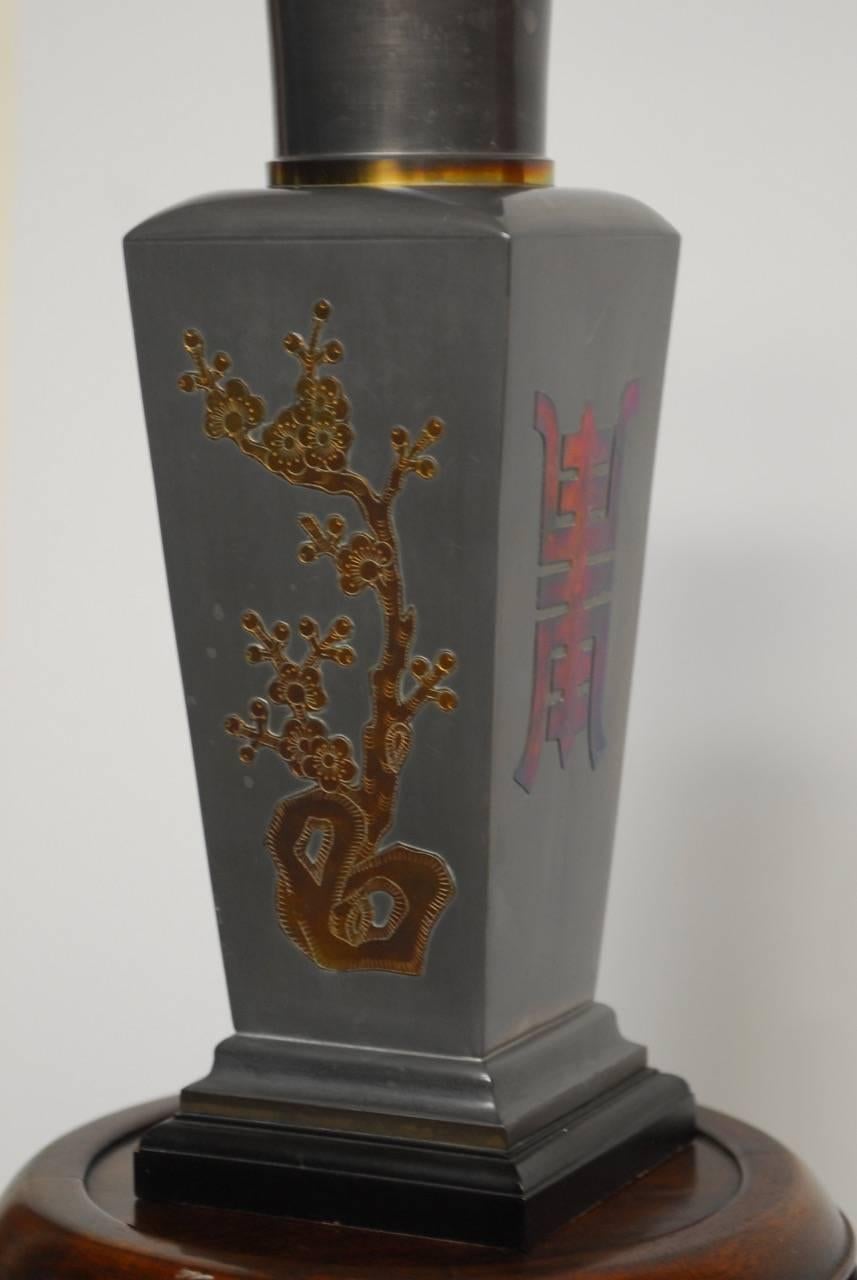 Mid Century Modern Chinese pewter and brass vase table lamp. Features a square pewter bodied vase with a round neck and brass ring highlights. Decorated on each side with bamboo motifs and prosperity emblems. Each emblem has an iridescent metallic