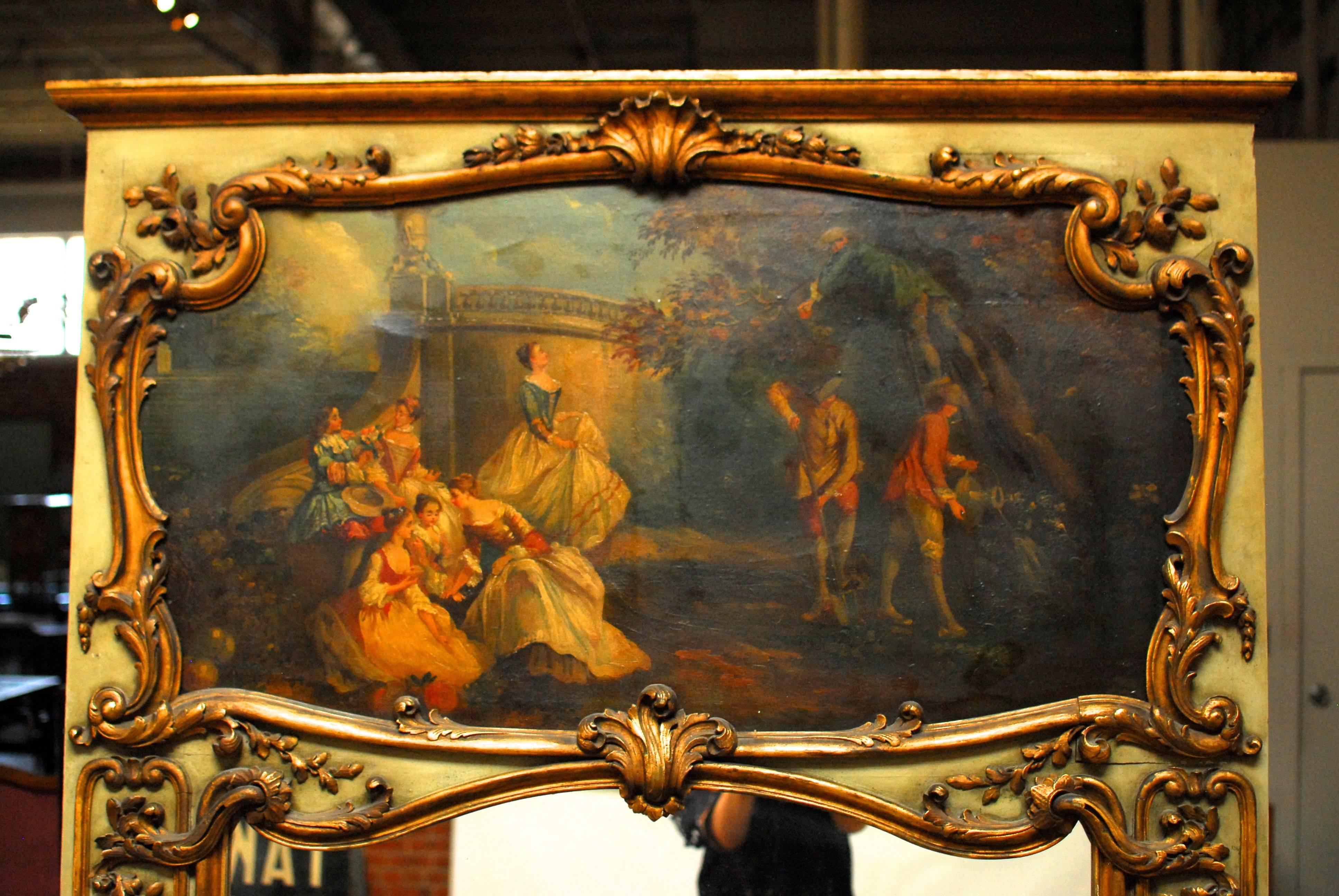 Monumental Louis XV Style trumeau mirror featuring an idyllic oil on canvas painted country scene. Parcel-gilt frame finished in a pale robin's egg blue and adorned with acanthus and floral designs with a shell crest. Dramatic size mirror that also