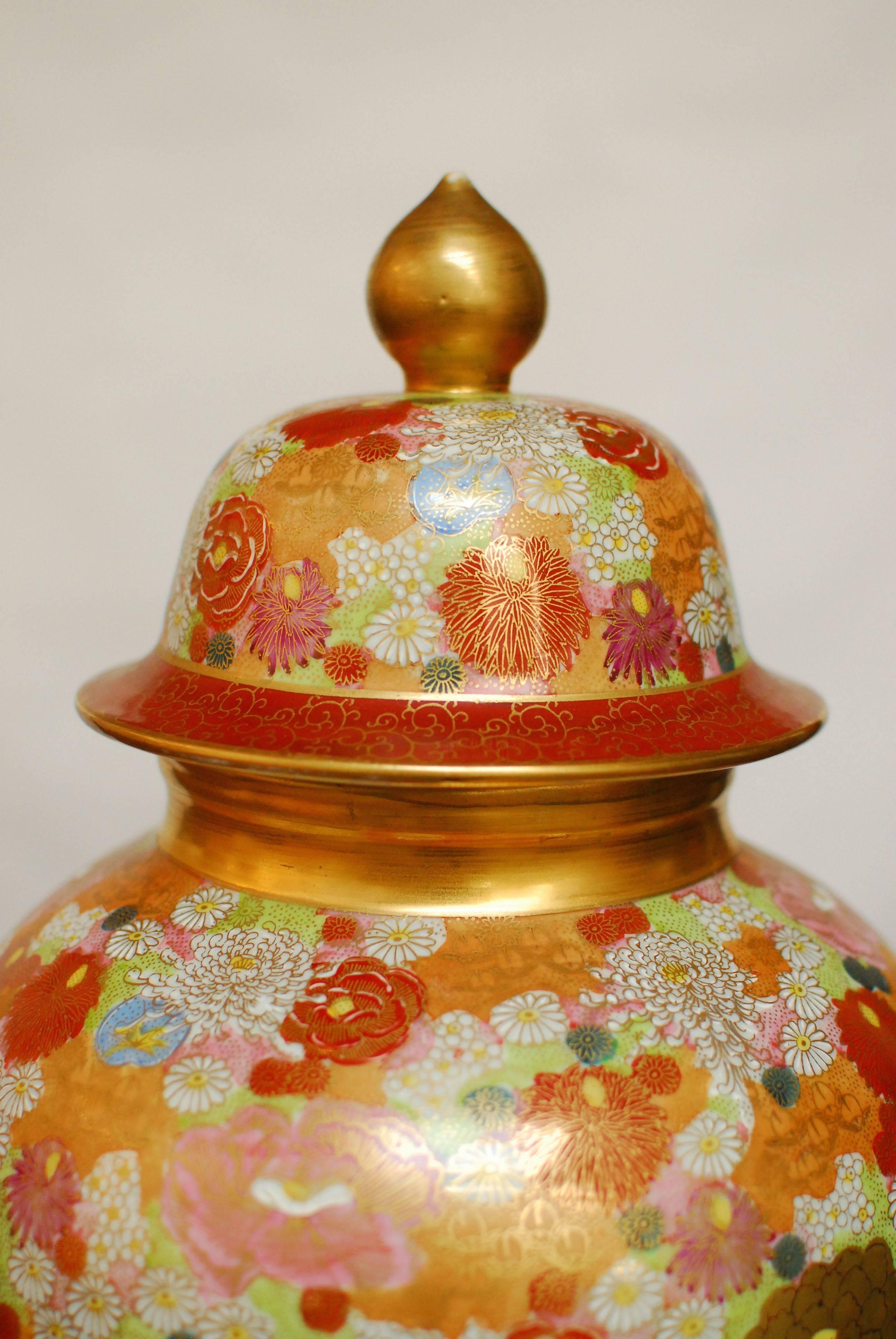 Japanese Satsuma ware ginger jar featuring a mille fleur design and gilt trim. Vibrant colors and marked on bottom.