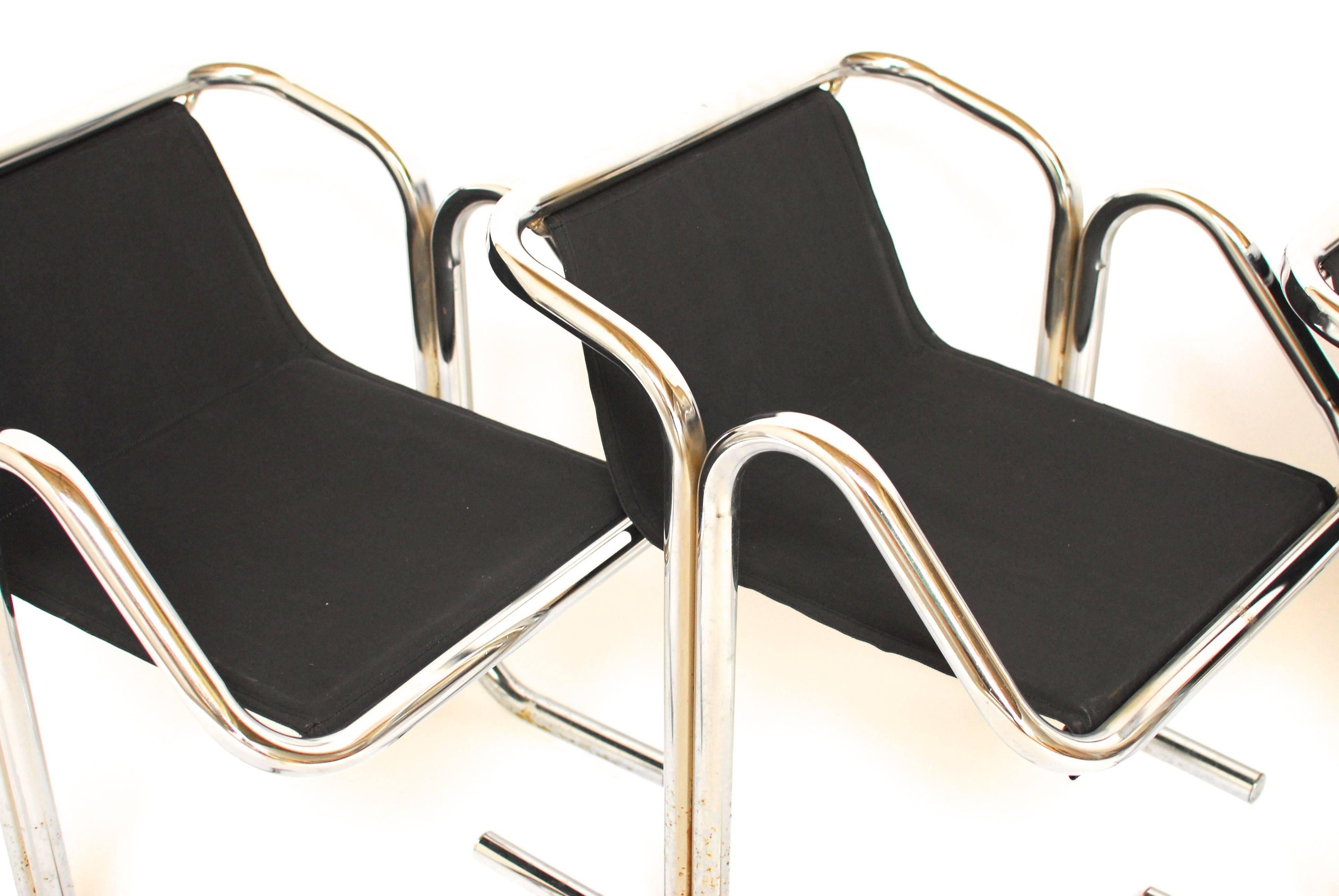 A set of Jerry Johnson Arcadia for Landes Manufacturing Company lounge chairs with chrome frames and black canvas slings. Each chair is made from two bent chrome tubes fused together. The slings on these chairs have just been replaced with new black