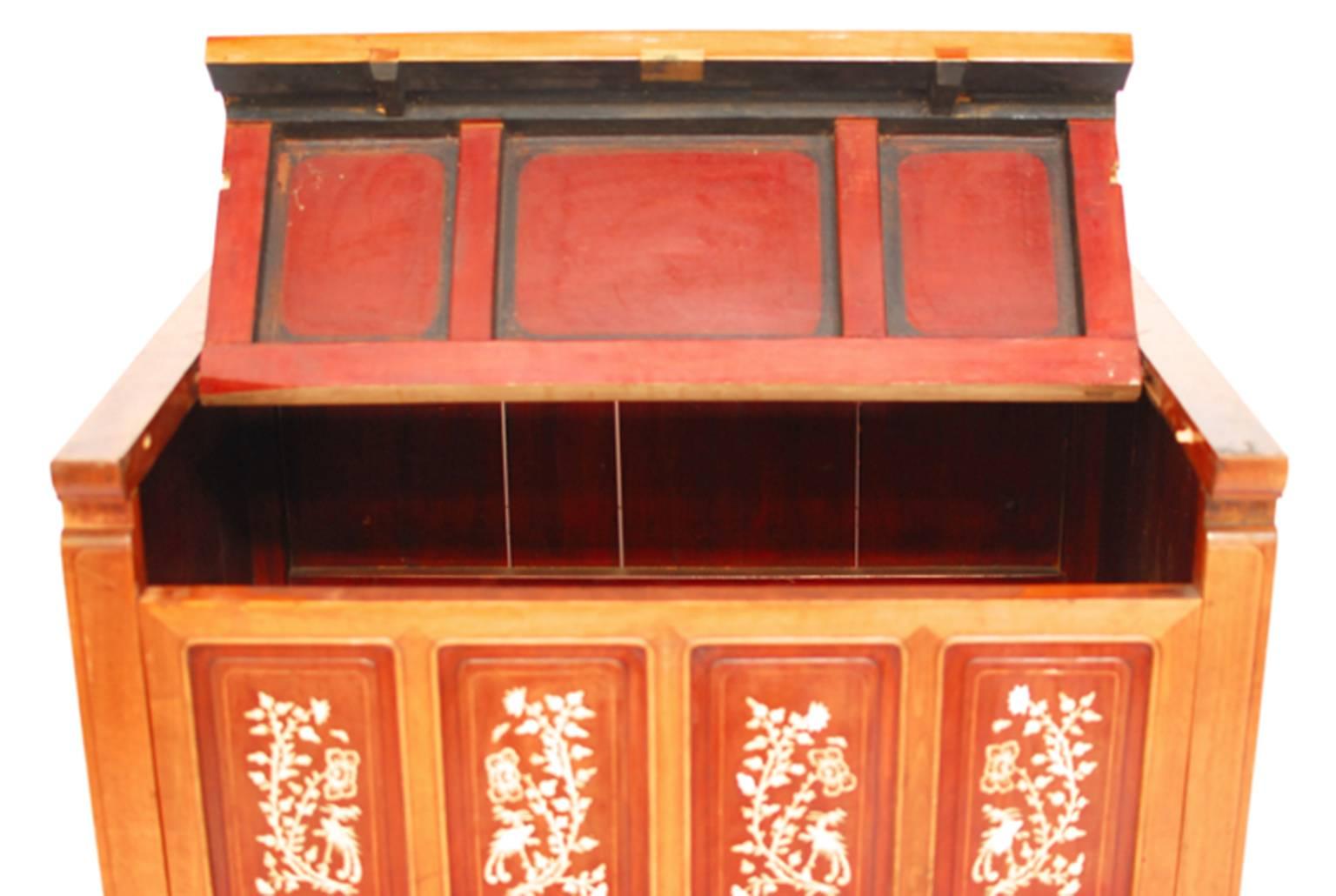 Antique Chinese storage chest from early 19th century Shanghai China. Opens with a slide on lid and has removable front panels. Eight inset panels on front. Bone inlaid with phoenix and peonies. Lots of minor losses to original finish but overall