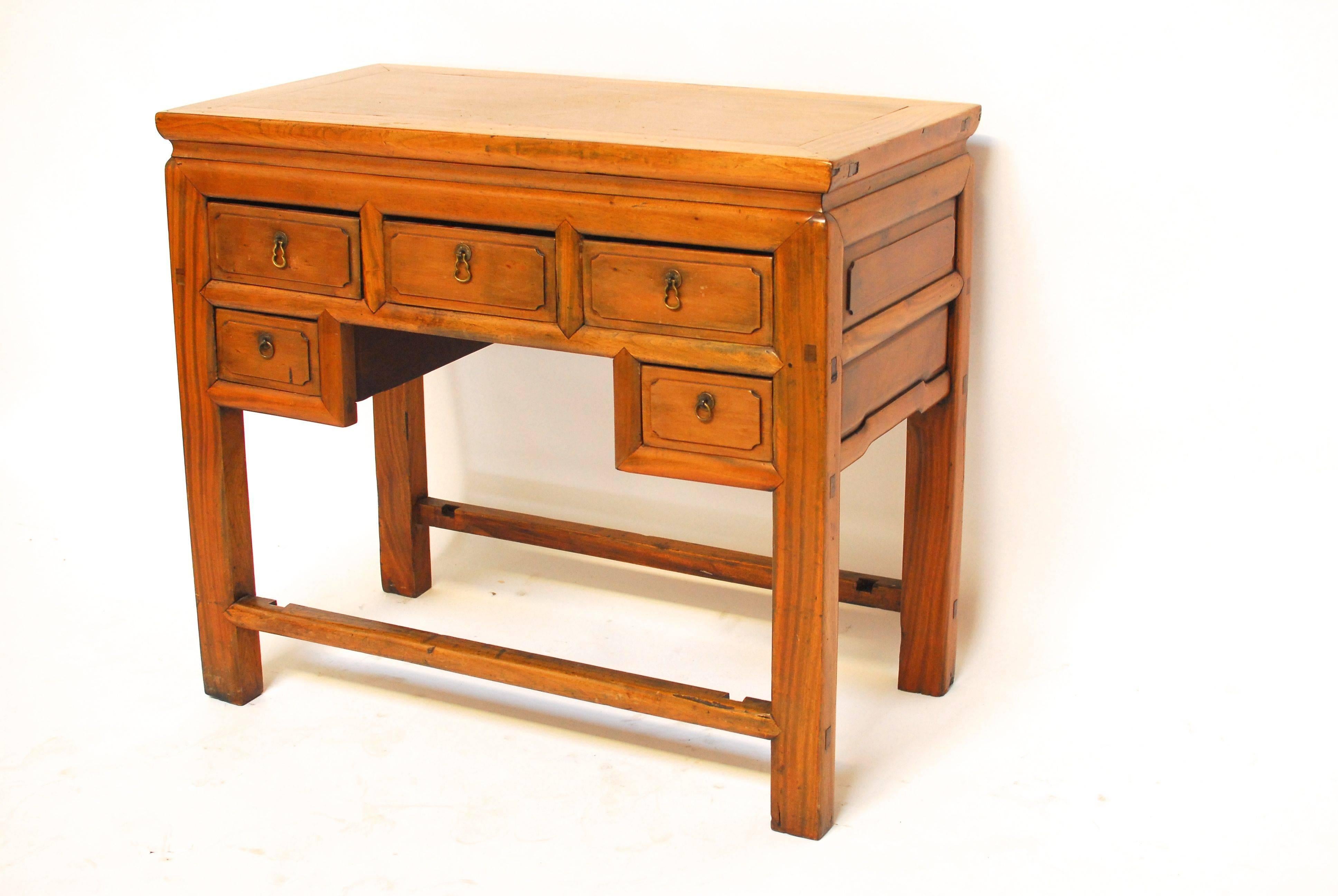 Antique Chinese five-drawer hardwood desk with rectangular paneled top on straight square legs. Stretchered footrest on front and back with detailed carving on back side also. Entire desk made with mortise and tenon joints. Good condition given age