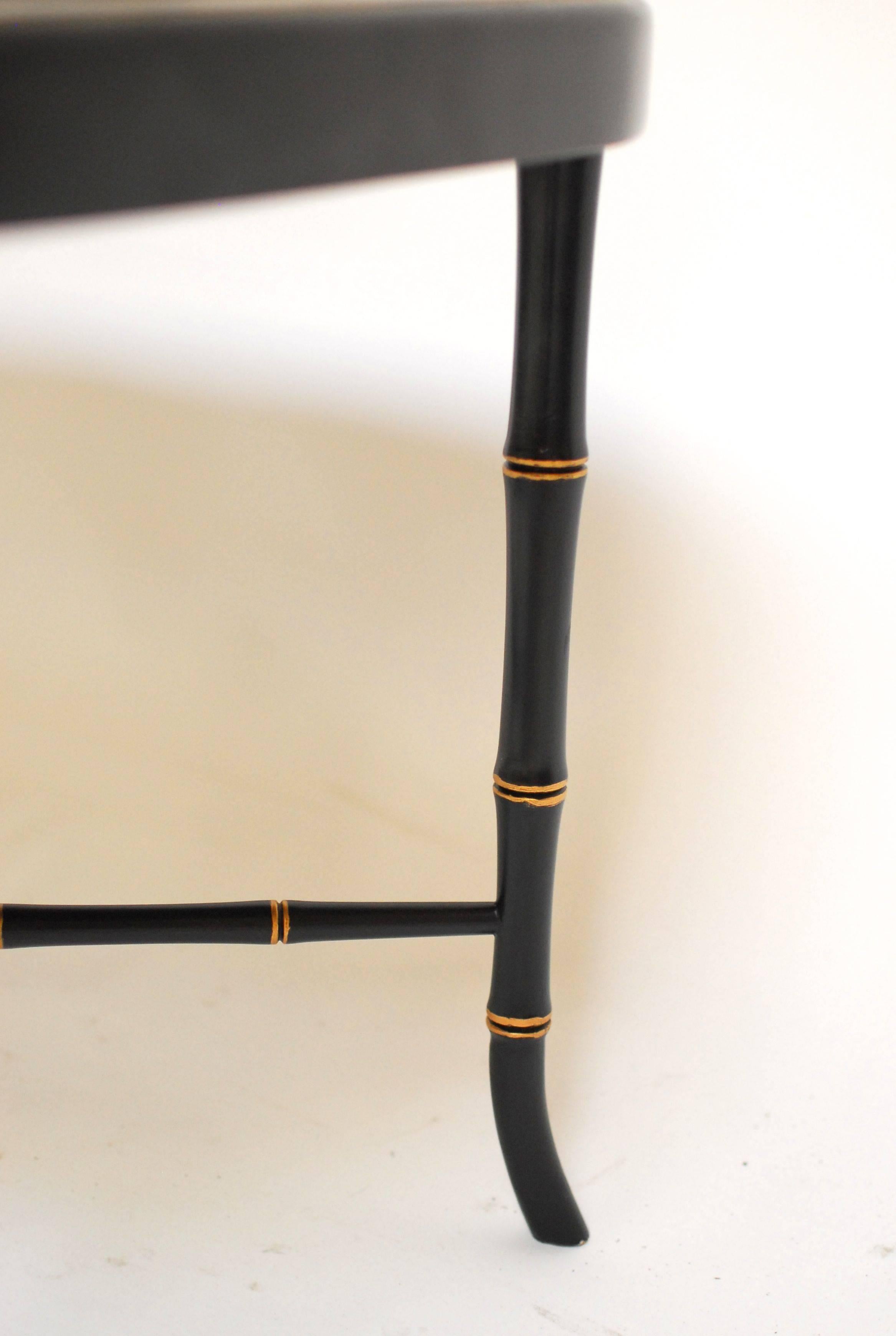 Antique French Chinoiserie gilt decorated metal tray table on a custom made an ebonized wood faux bamboo stand. Beautifully painted tray with intricate detail done in the Asian taste. Sits on a custom wood stand featuring faux bamboo legs and