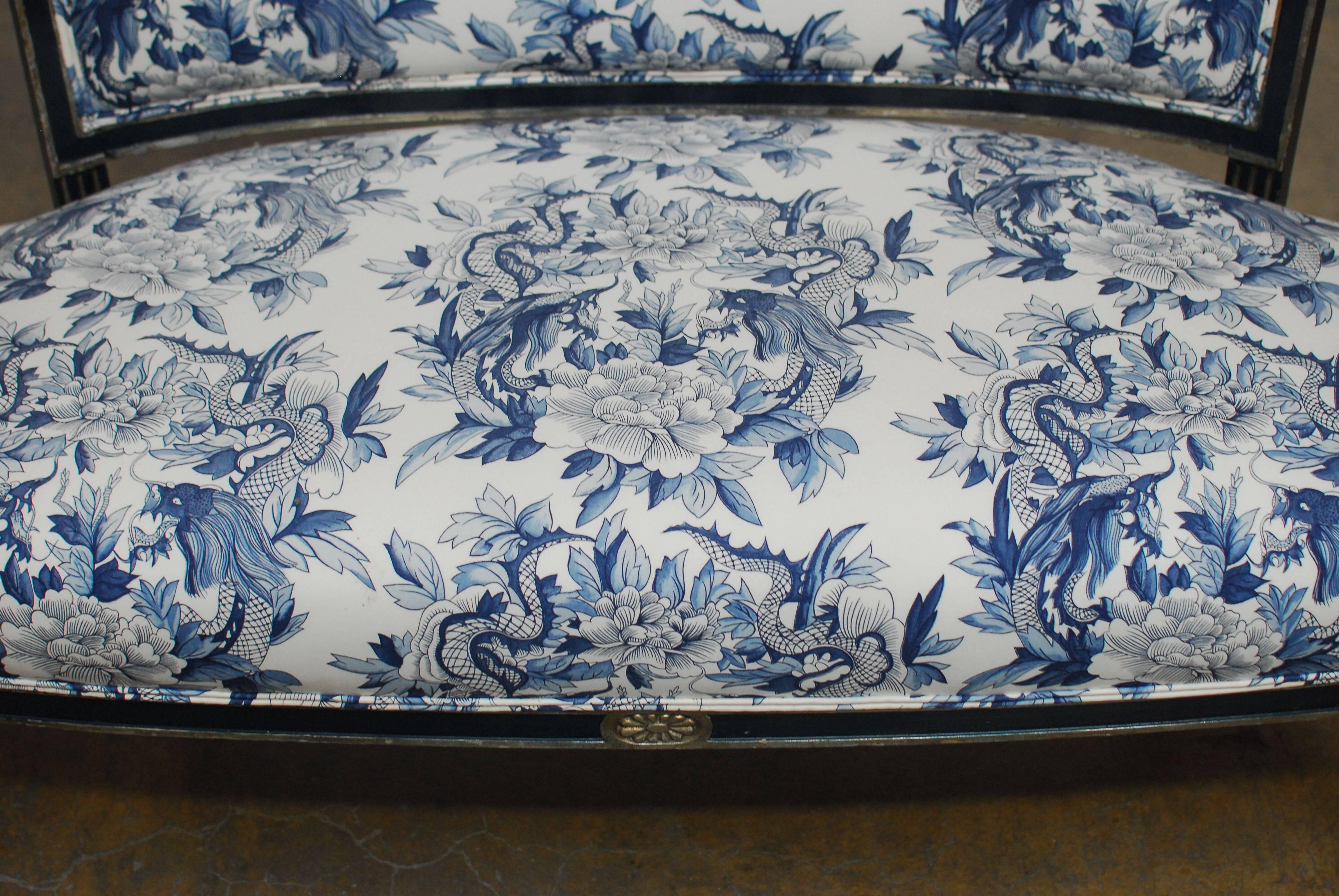Striking French Directoire style settee finished in a dark royal blue frame with silver trim and banding. Featuring a Ralph Lauren toile chinoiserie blue and white upholstery with dragon and foliate decorations and a double welt border. This settee
